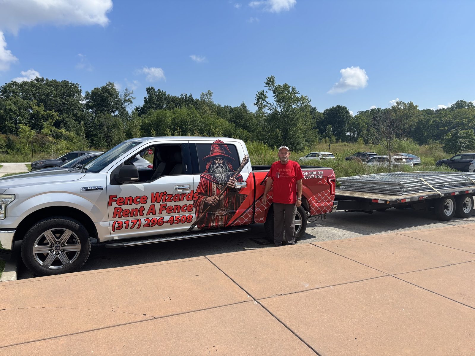 Fence Wizards pickup with a trailer stacked with fence panels