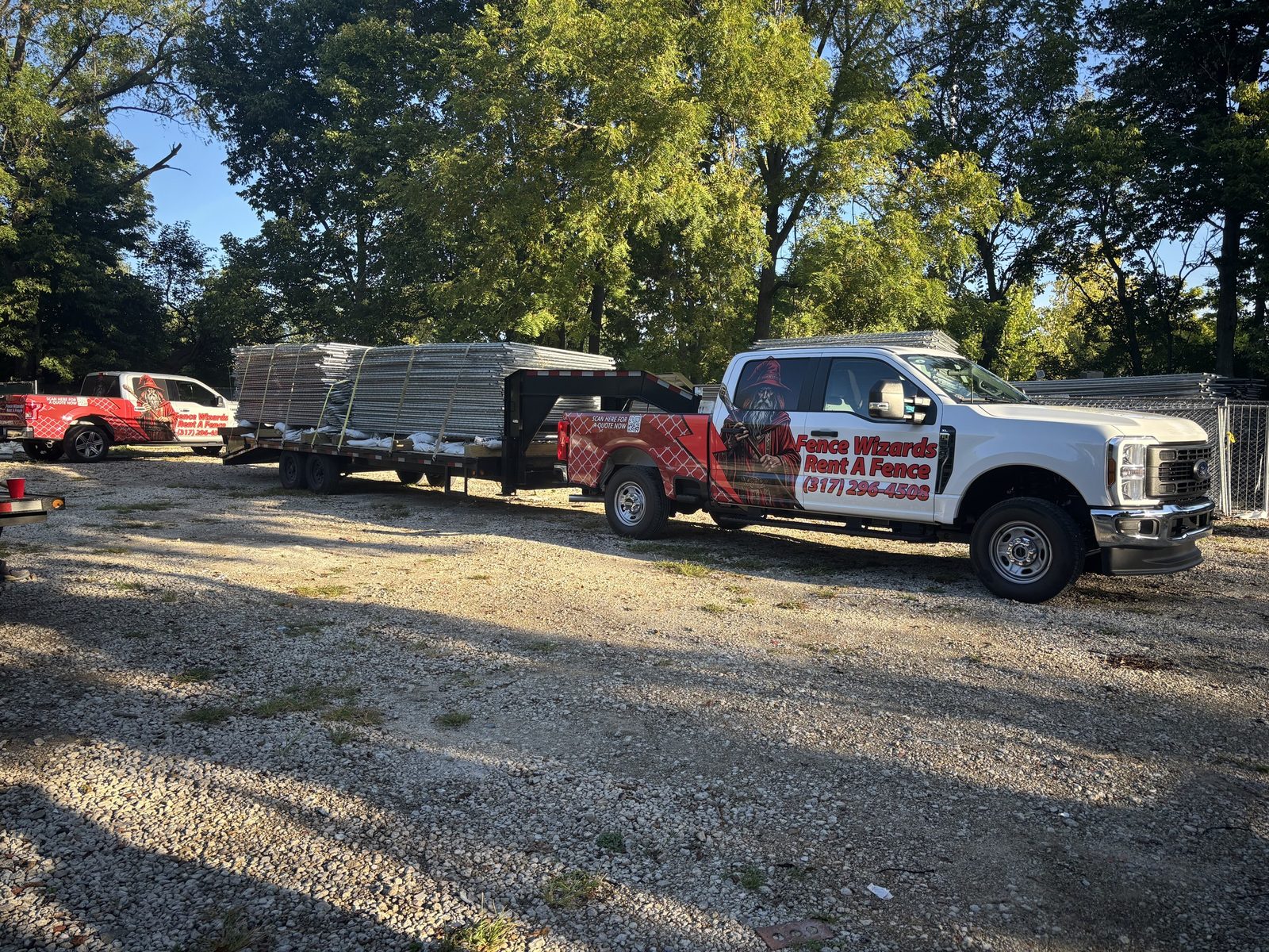 Fence Wizards truck and trailer loaded with fence panels